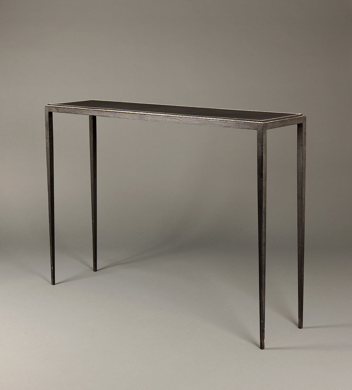 Console designed by Jean Michel Frank and made by Comte, Argentina. Metal frame and tapering legs. Leather covered table top with thick white contrast stitching. This console epitomises Jean Michel Frank's taste for luxurious materials and pureness
