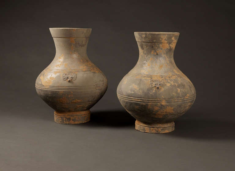 A Pair Of Very Important Chinese Vessels From The 2nd Century BC, With a Small Detail Of A Head On The Front And Back Of Them.