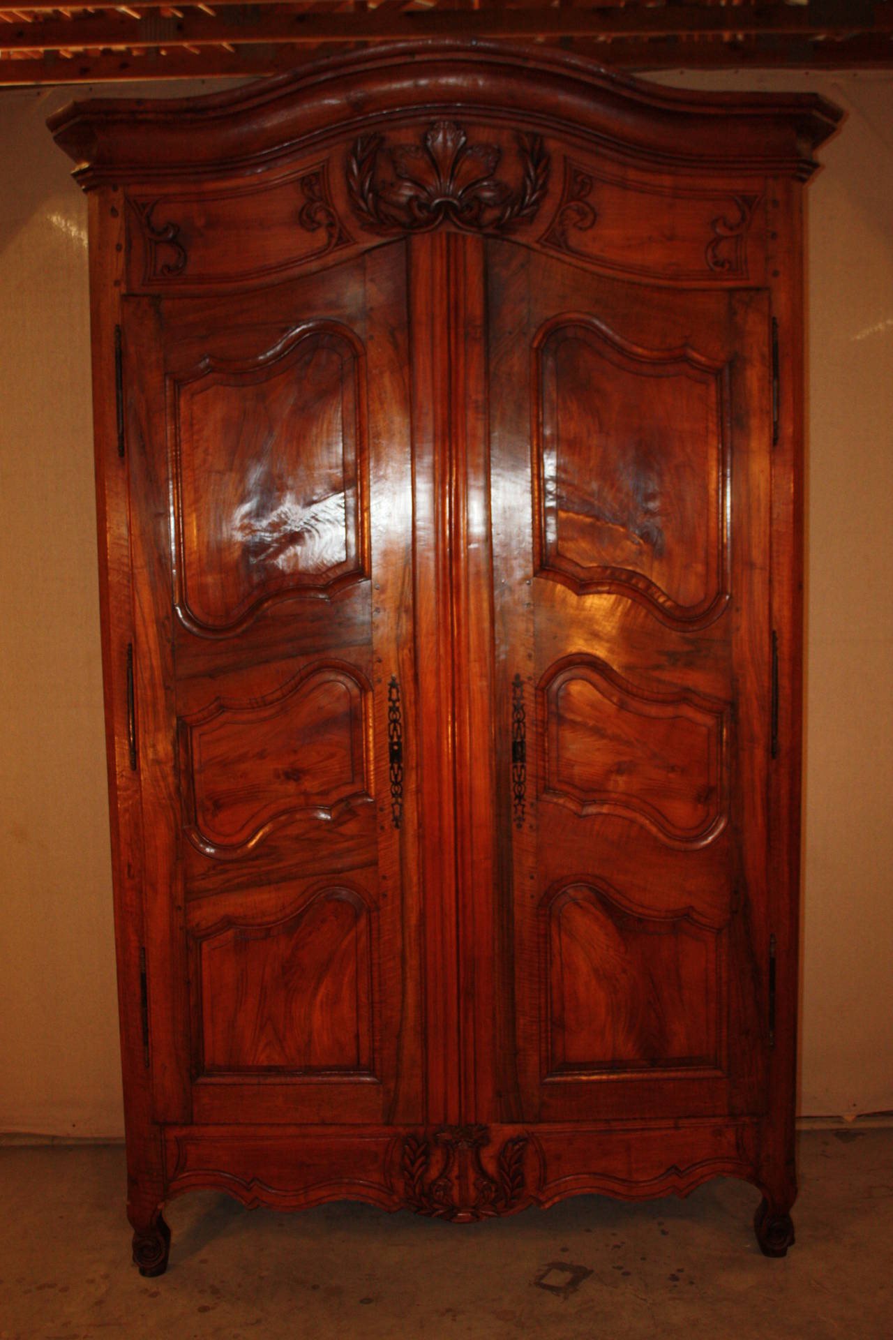 This is a beautiful French walnut armoire.  It has two shelves.  The patina of the walnut is excellent.  The carvings are very nice.