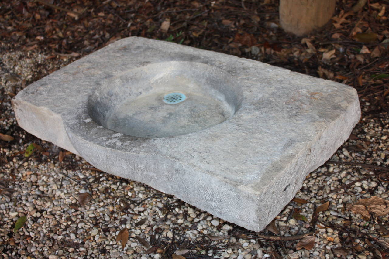 This is a very good looking French limestone sink I purchased in the south of France.  It is in very good shape for its age. It still has the original drain cover which is rather rare.  The chisel marks are still visible in the stone.