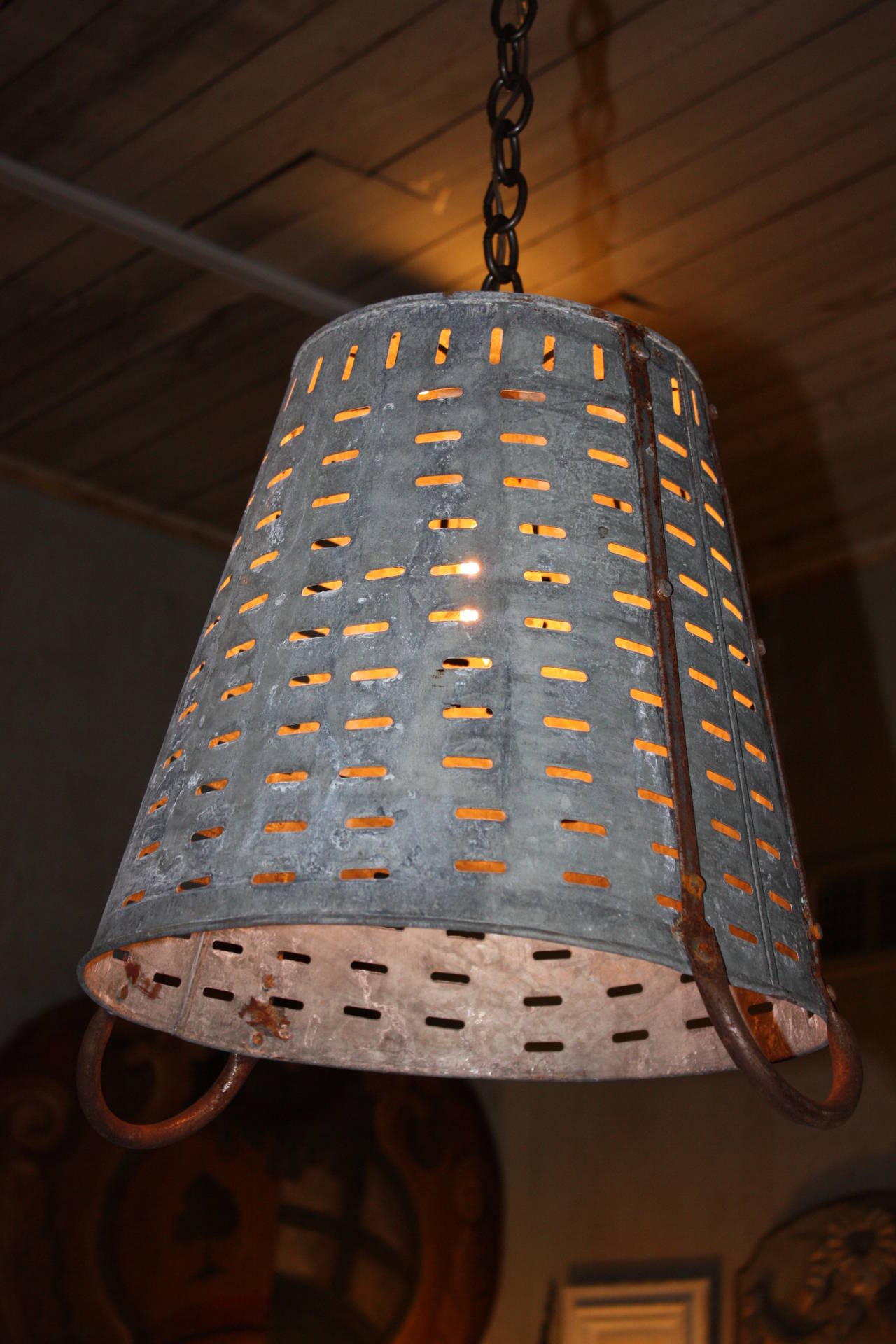 This is an olive basket I had wired. It has a great look. The basket is galvanized metal with metal handles. It is pictured with an Edison bulb, not included, which is very attractive. There is 3 feet of chain on each light and a canopy. All
