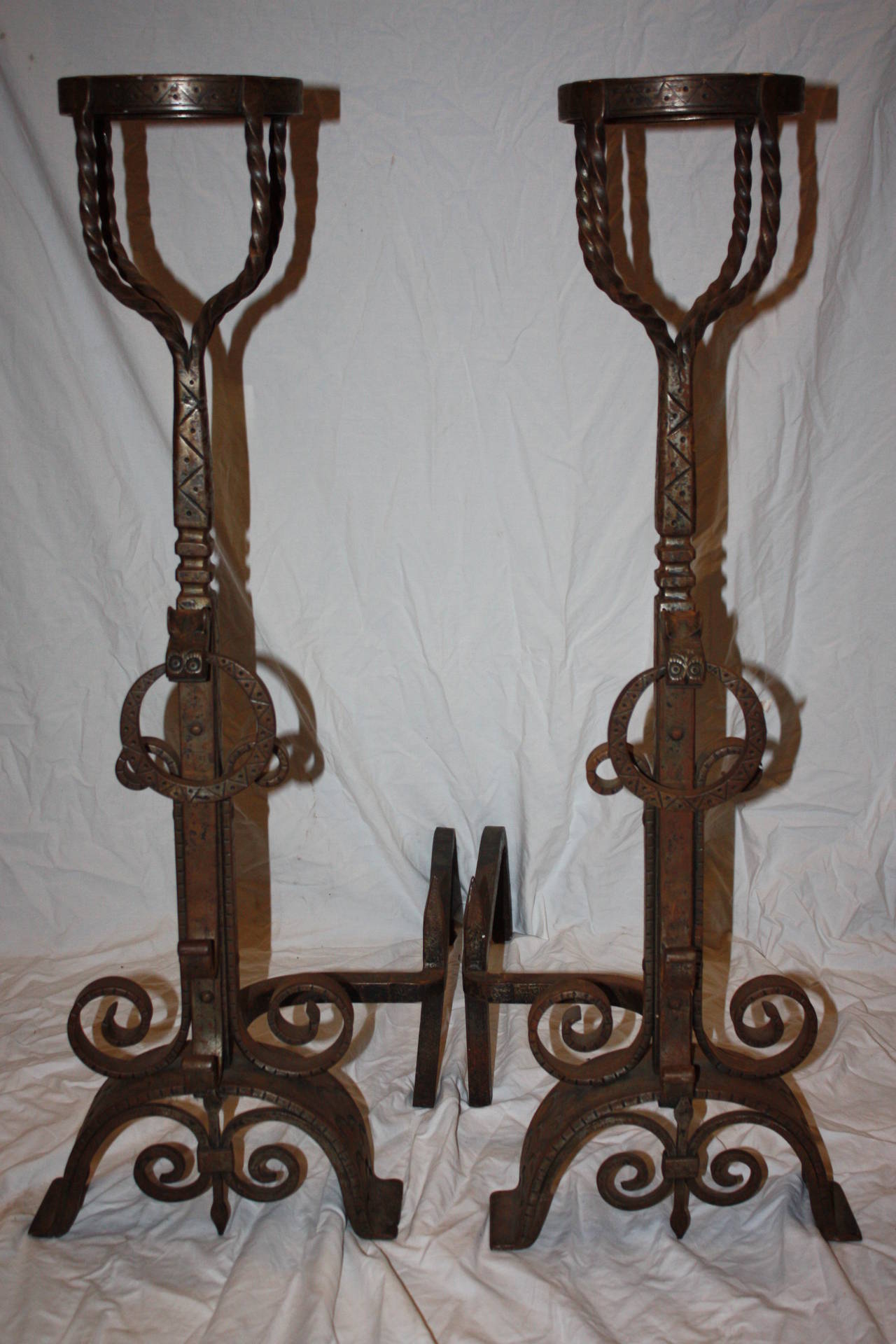 This is a really nice pair of wrought iron andirons I purchased in France.  They are accompanied by a pair of matching fire tools that hang nicely from the top of the andirons.   The andirons are very large in size.  The iron work is exceptional,