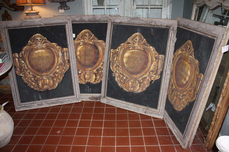This is a set of four Italian Paintings of shields being topped by skull and bones and below by an owl.  Each has a Latin verse from the bible.
