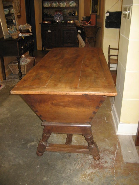 French provincial petrine (dough bin) made from walnut.  From the late 19th century the piece has a beautiful patina. The wood plank top lifts completely off the base to reveal the bin that was used to store the dough.  The piece is on its original