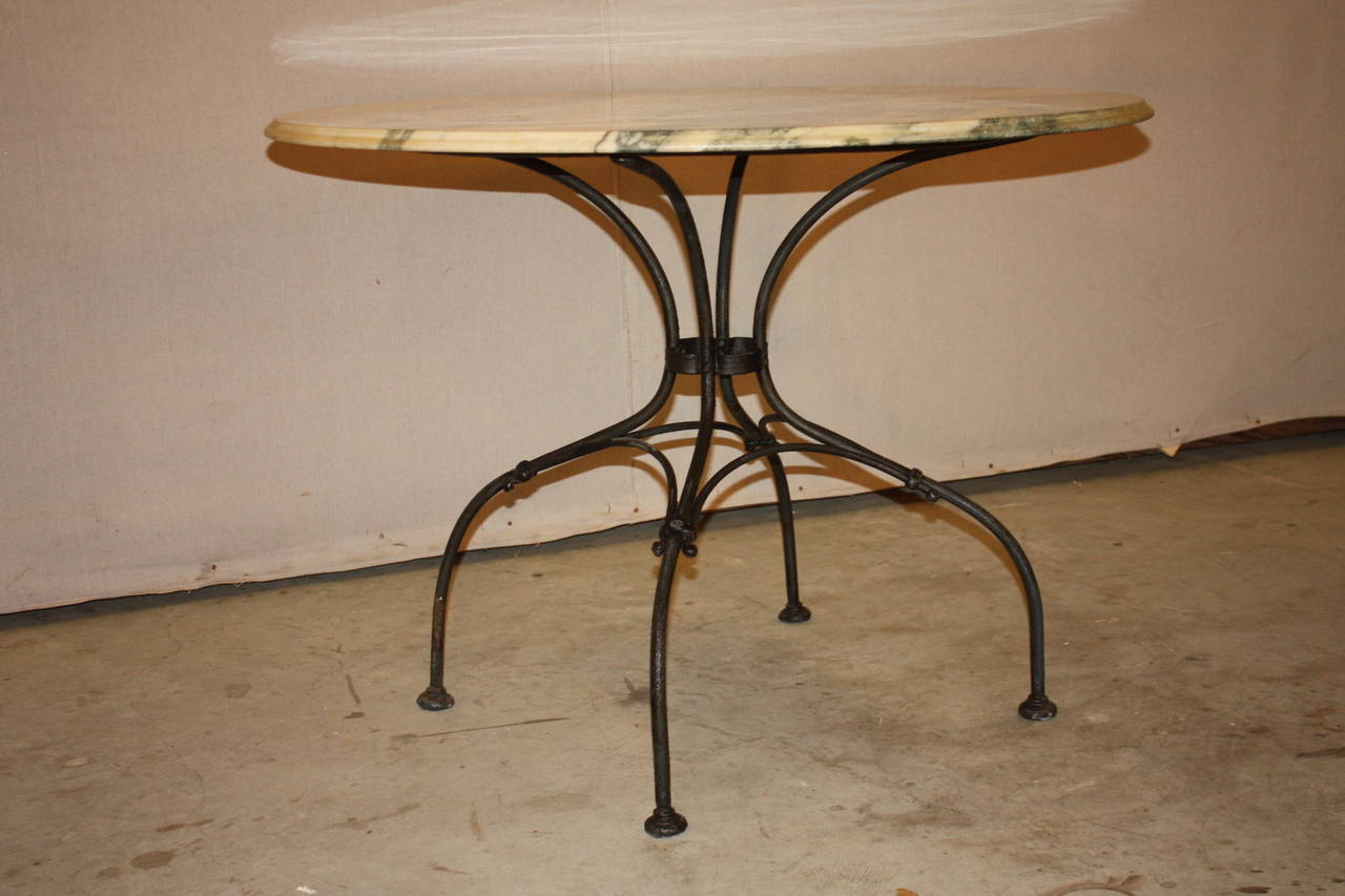 This is a very nice large round marble top bistro table I purchased in France.  the base is wrought iron with a very nice unique design.