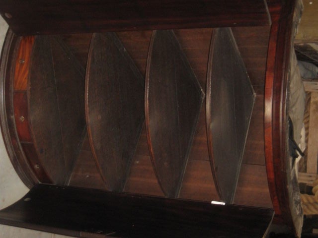 Rounded front hanging corner cabinet.