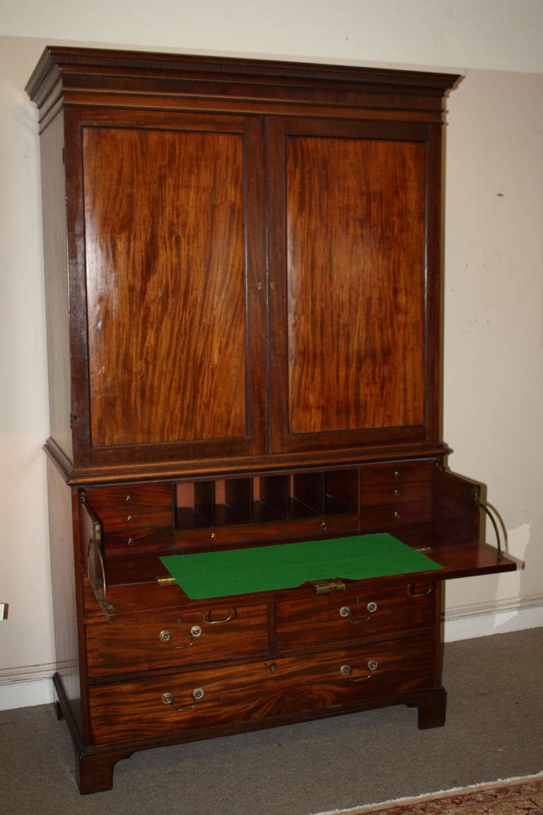 This is a great looking English linen Press with a fall front secretary from the late 1800's.  The linen press has a single drawer across the base followed by two rows of side by side drawers.   followed by the faux drawers that hide the fall front