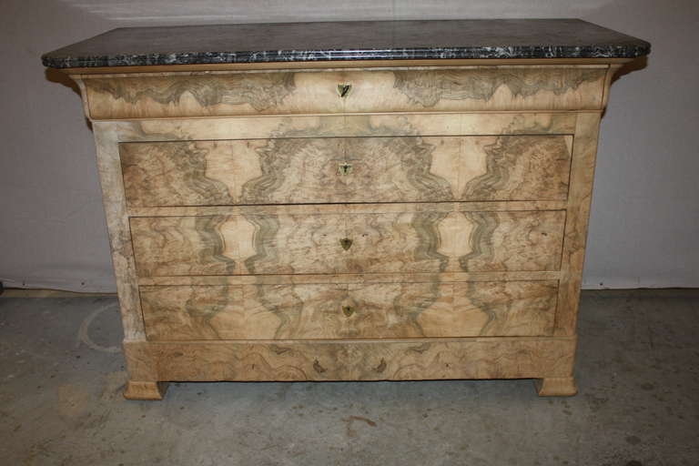 This is a French bleached burl walnut commode with a marble top.  It dates to the late 1800's.  The bleached burl walnut gives a very modern look making a good candidate for any style home.