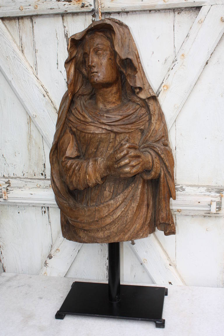 This is a really beautiful hand carved statue of a weeping Mary Magdalene.  It is Italian in origin.  The statue dates to the 18th Century.  The stand is modern.  The stand is very well made, attractive.