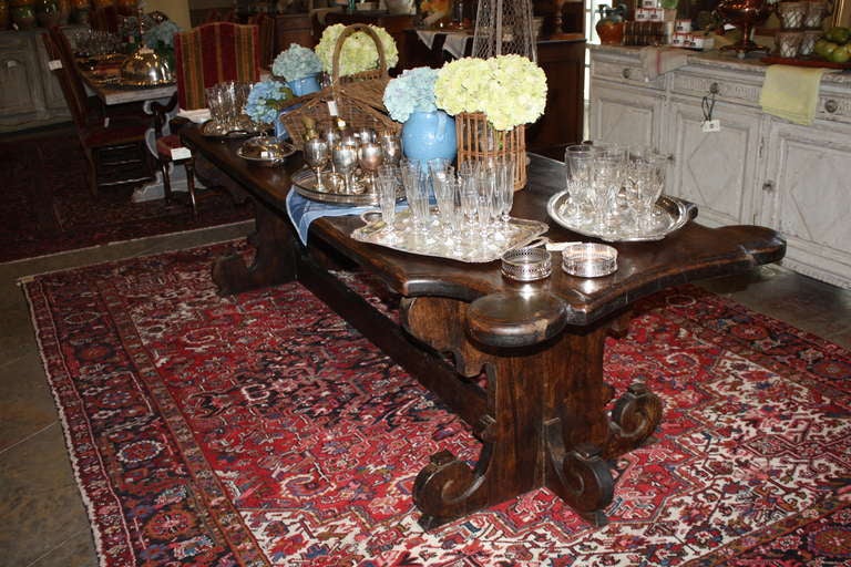 This is a really fine large Italian walnut trestle style dining table that supposedly came from a monastery in Umbria, Italy.  It is very unique in its style.  It sits eight easily and I am pretty sure it could sit ten.The patina of the wood is very