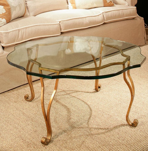 1950s gilded Metal Coffee Table with Openwork Legs ending in Scroll Feet and a shaped Glass Top