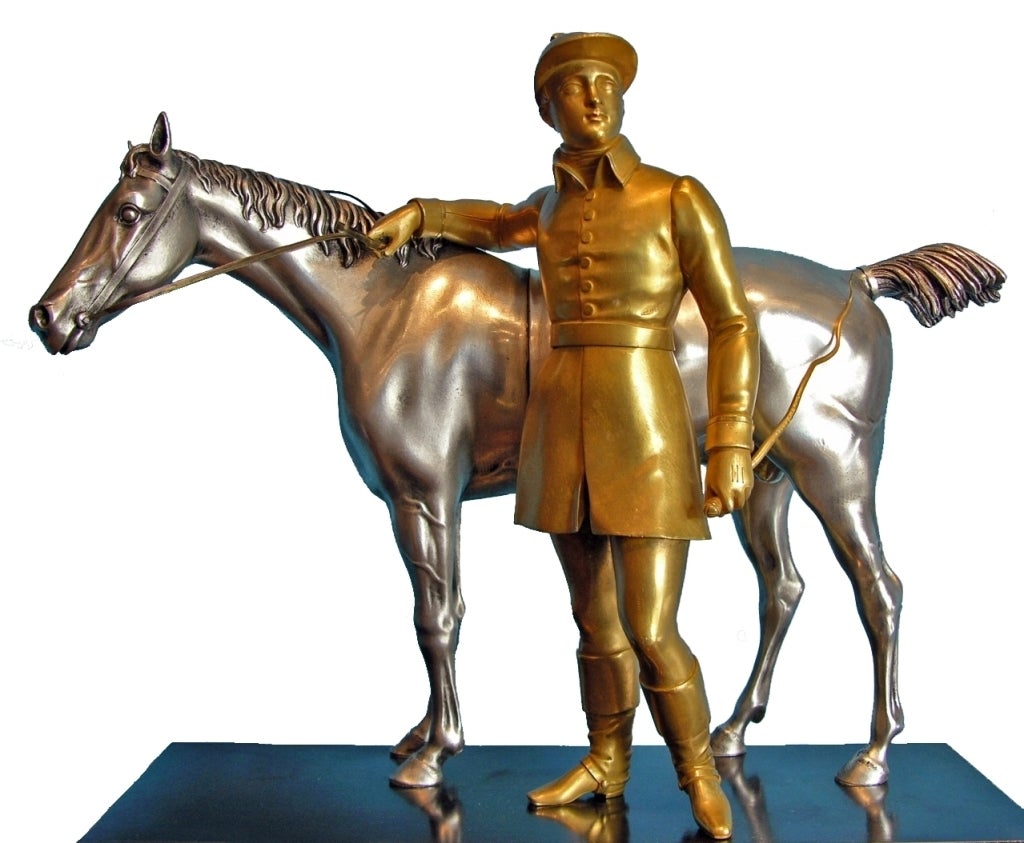 Sculpted racehorse with jockey standing on a decorated rectangular plinth