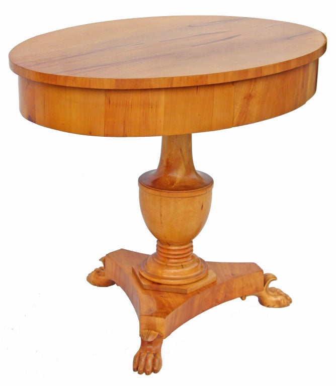 Oval table with one drawer. Tripod base supported by three carved claw feet