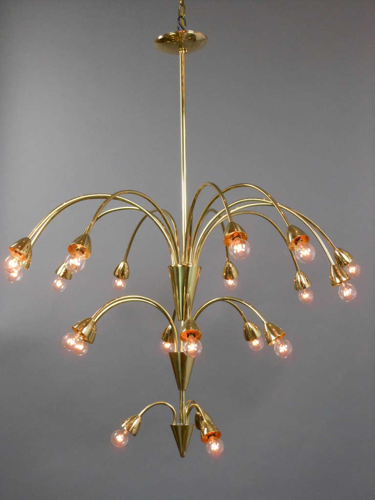 This 1960s chandelier stands out with its playful spray of 21 lights issuing from a vertical standard of three cones.

 