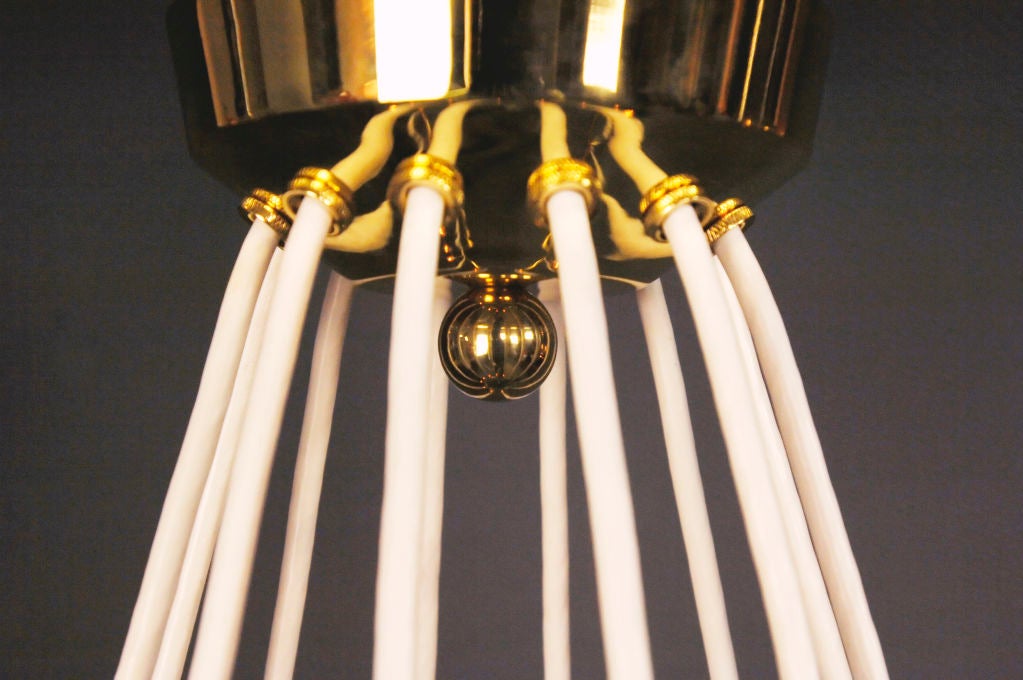 The canopy issuing cords supporting the circular frame fitted with 14 L-shape candle holders.