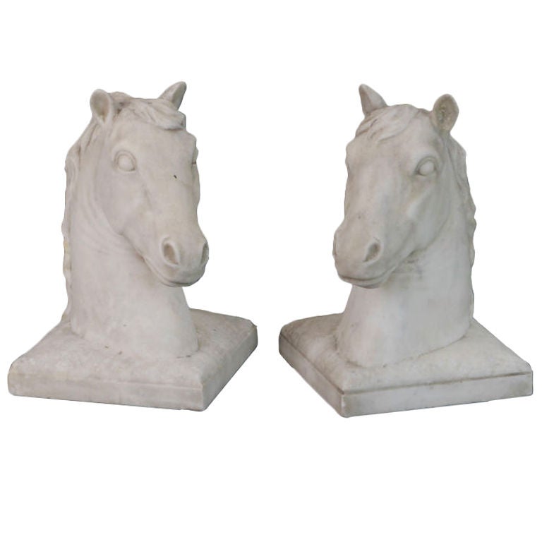 The horses, naturalistically carved with flowing manes, rest on a square cushioned base. Their lively expressions complement one another.