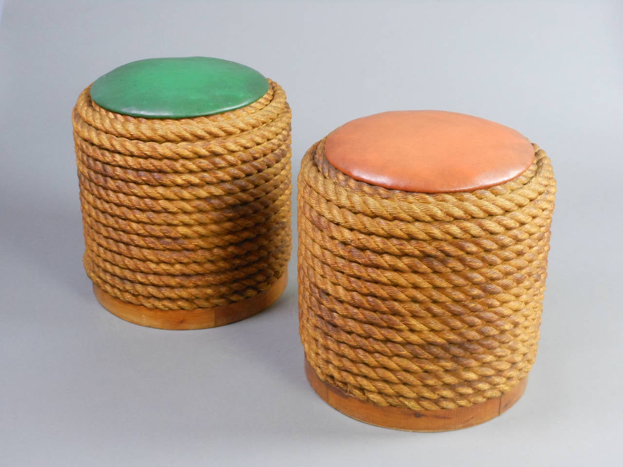 Each of cylinder form composed of coiled rope with vinyl seat covers.