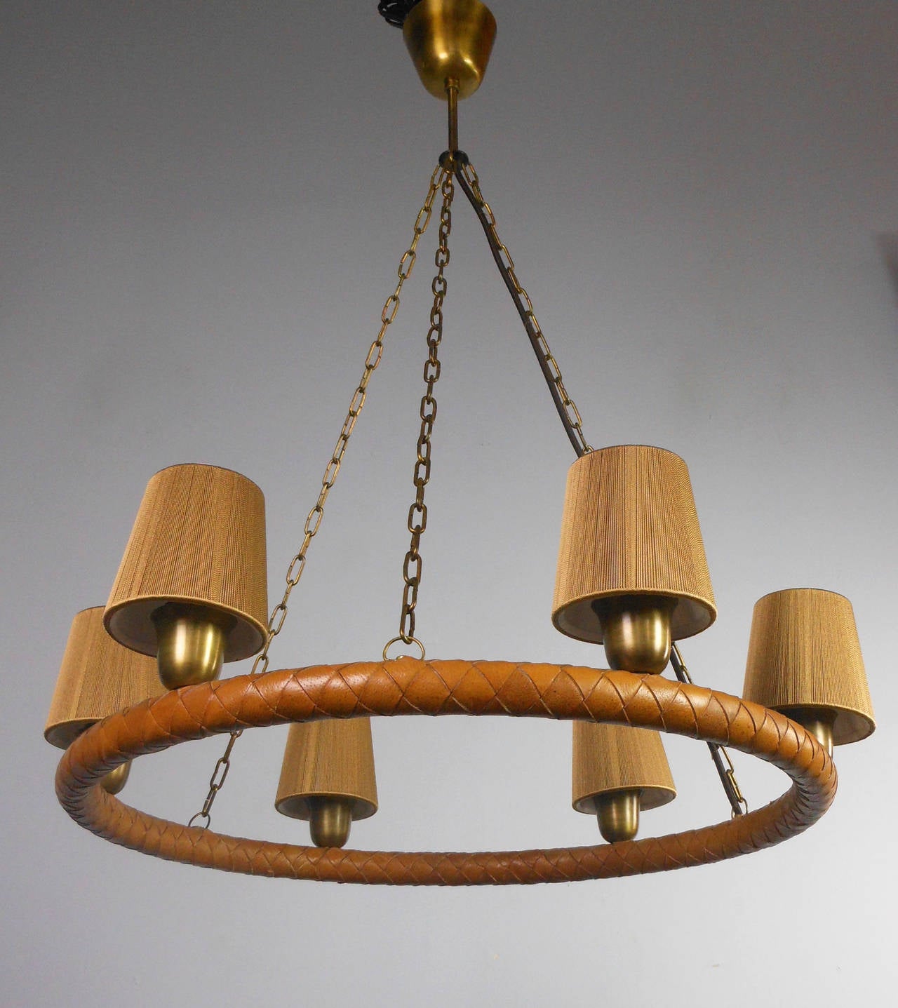 The circular domed canopy issuing three chains, the leather wrapped ring supporting six lights.