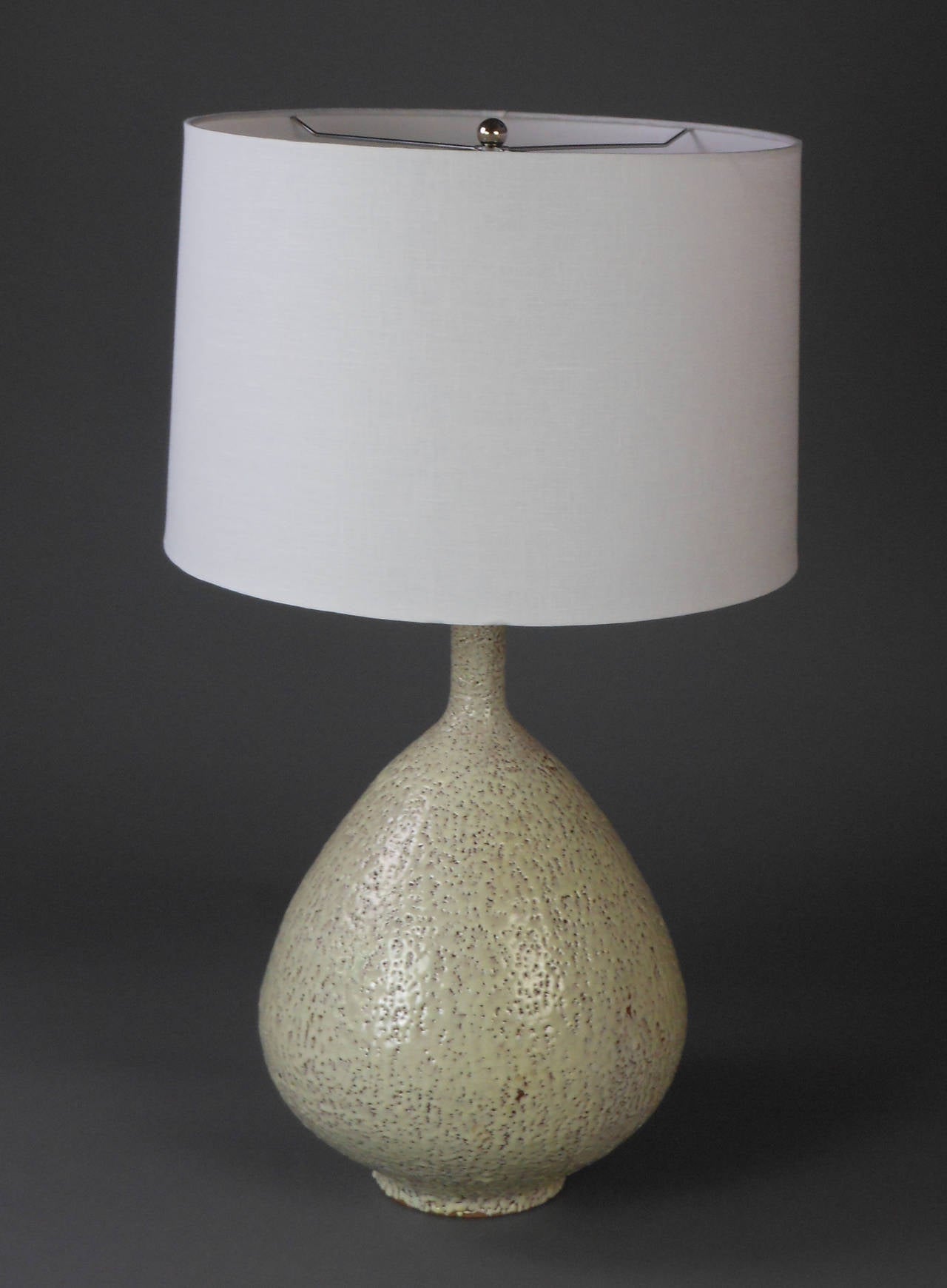 This rare large earthenware lamp by Jacques Garnier has a beautiful teardrop form with a textured cream-colored glaze. Incised AV (Argile Vivante).

Height to light fitting 19"
Height to top of shade 32"

Jacques Garnier (1934-1998)