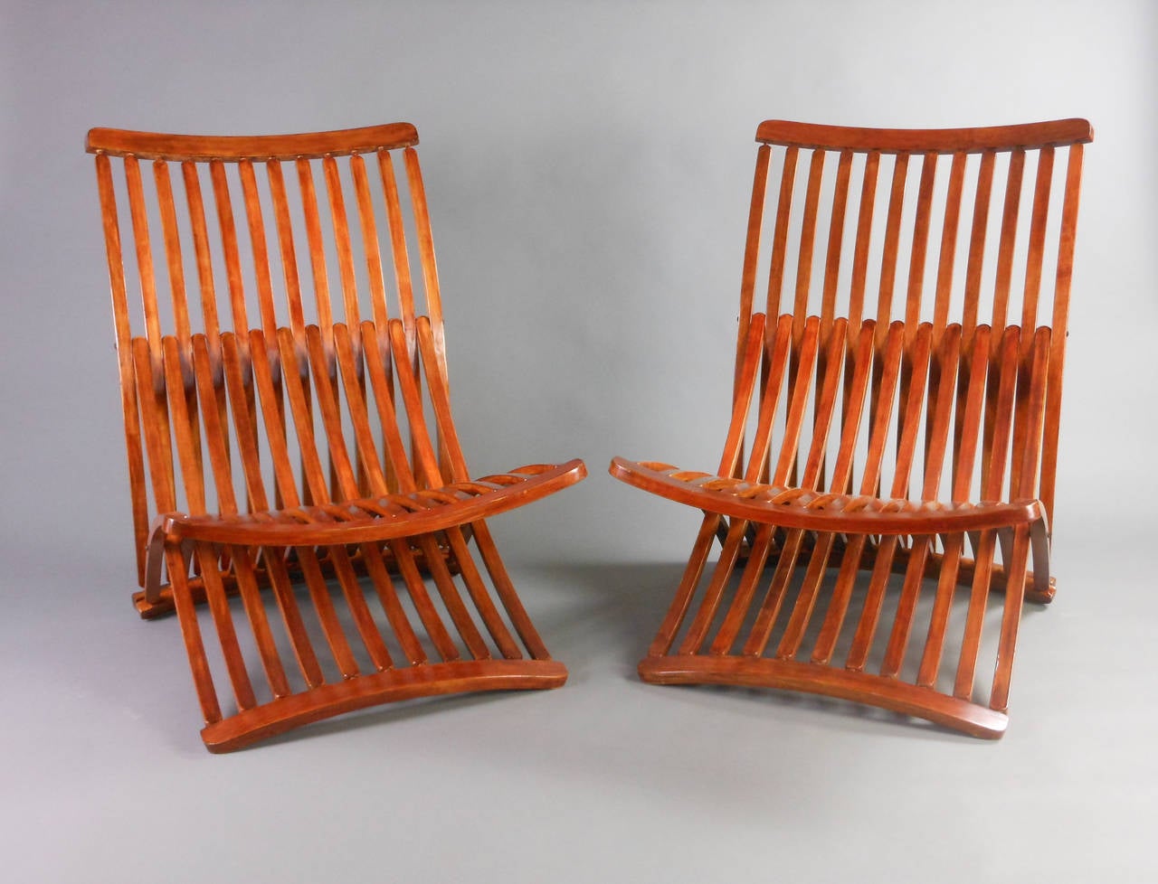 Each birch chair composed of three slatted arcs. Designed by Thomas Lamb, the steamer chair became the first Canadian object to enter the Museum of Modern Art's permanent design collection in 1979.