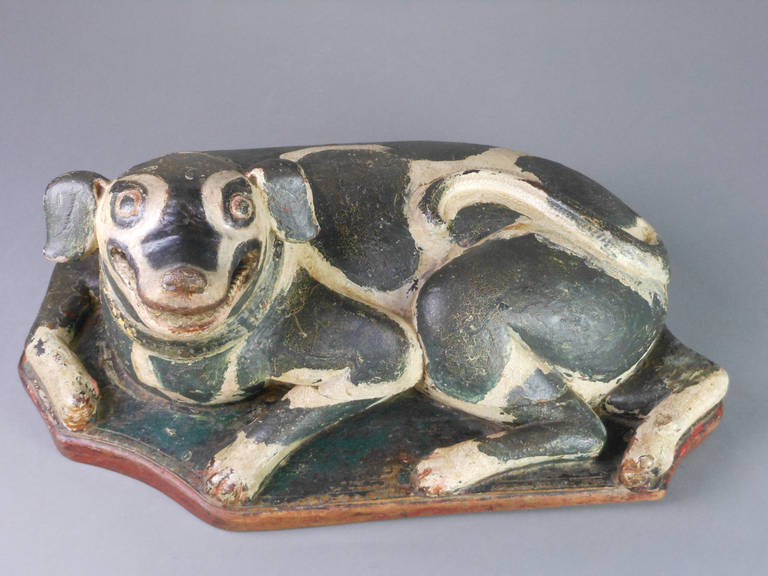 This Indonesian box takes the form of a seated dog that swivels open to reveal compartments.