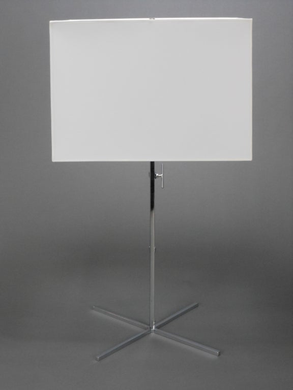 Each light has an adjustable rectangular standard on an X-form base.