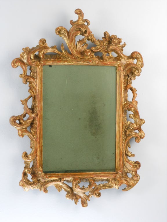 This continental rectangular pair are a mirror image of each other. The C-scroll crests each face inward. The frame consists of a molded border surrounded by pierced foliate C and S-scrolls.