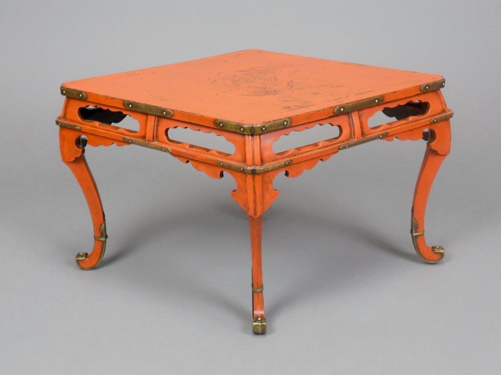 This unusual Japanese lacquer table has a diamond-shaped top and an apron with cloud form openings. The bracketed cabriole legs end in brass sabots. It is signed on the underside.