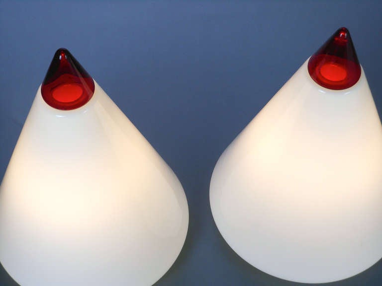 This very large pair of Mid-Century Modern lamps are a white cone shape with a red tip standing on a metal base. Can be used as table or floor lamps.

Born in Murano in 1939, Giusto Toso's lights are included in the collections of the corning