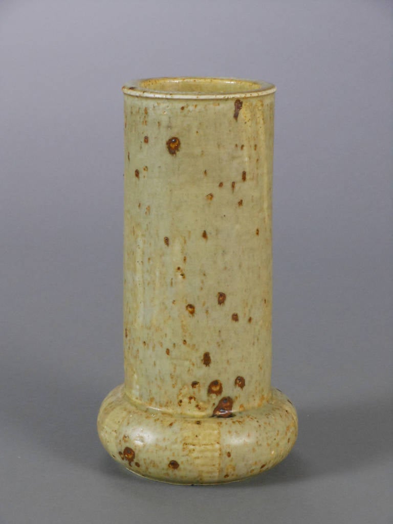 The Swedish glazed earthenware vase is cylinder-shaped with rounded base. Marked on the underside R with 3 Crowns MW ATELJE SWEDEN AM 33.

Marianne Westman (b. 1928) is a Swedish potter and textile designer, and one of Sweden's foremost designers