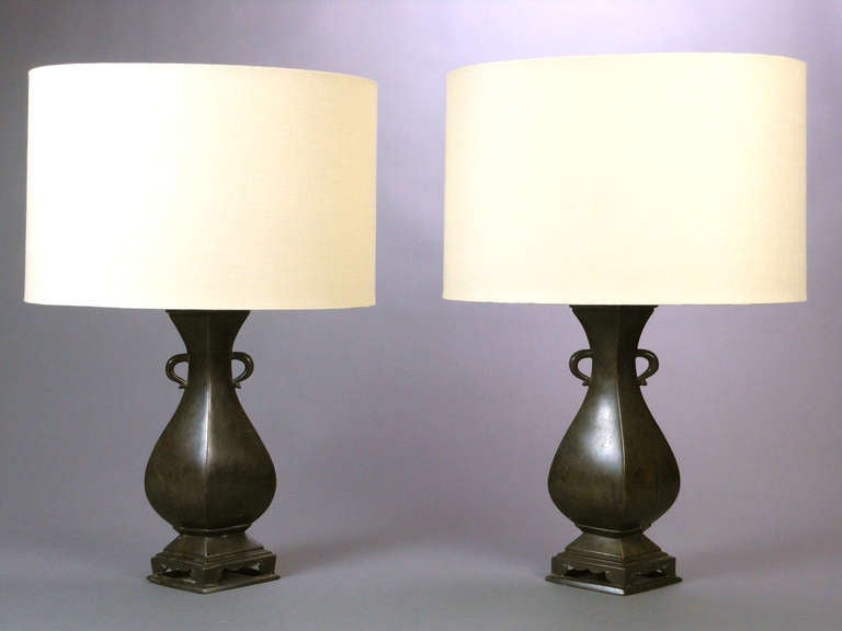The rhomboid shaped lamps have a tapering neck with C-shape handles and a stepped and pierced base.

Height to base of light fitting: 12"
Height to top of finial:  21"