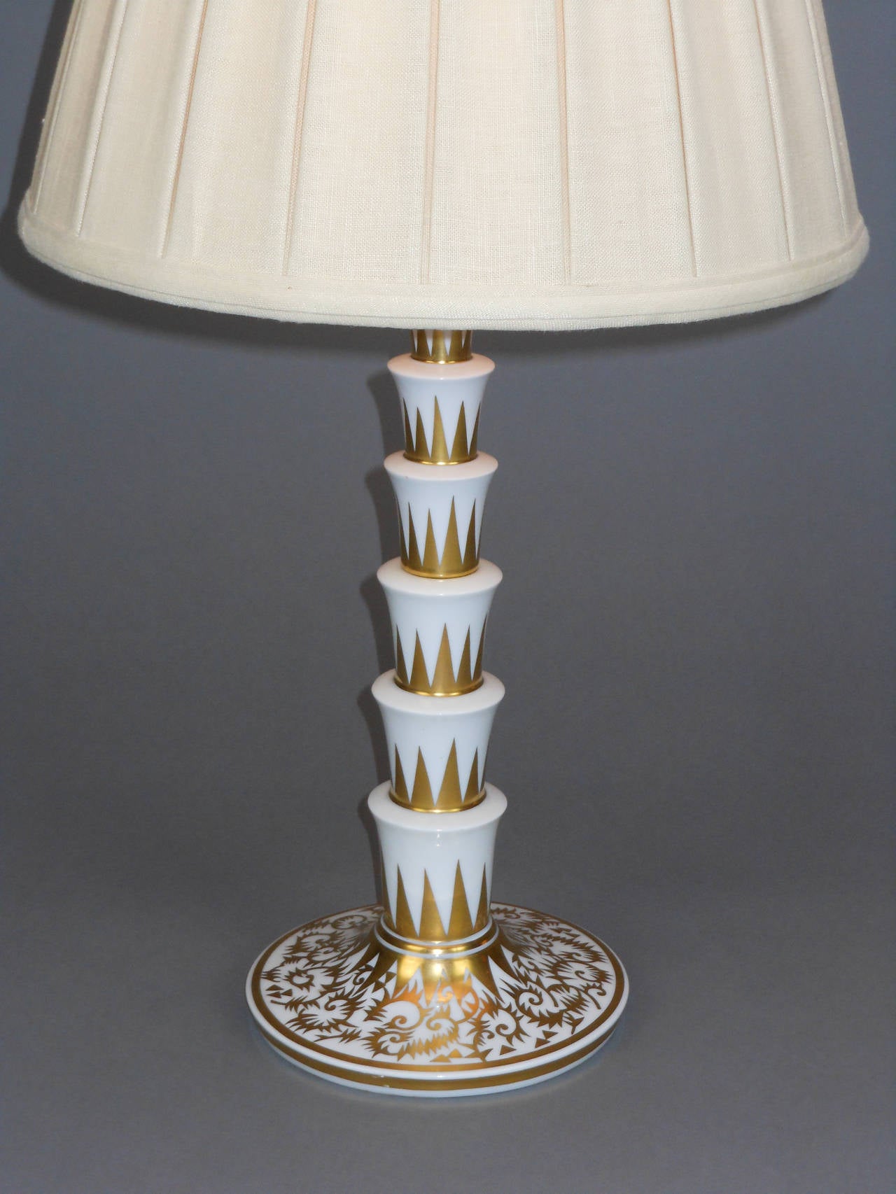 This German Rosenthal lamp features a column of cascading tiers above the domed circular base.

Marked: 50 JAHRE 50 DIE WELTMARKE Rosenthals SELB BAVARIA
Measures: Height to light fitting 15"
Height to top of shade 25".