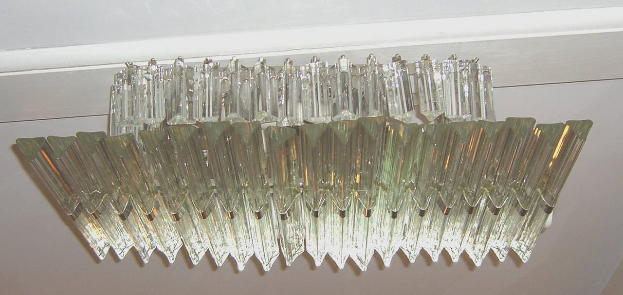 A rare design of 19 triedre glass hanging horizontally with smaller triedre hanging vertically above. Chrome accents add to the glitter effect.