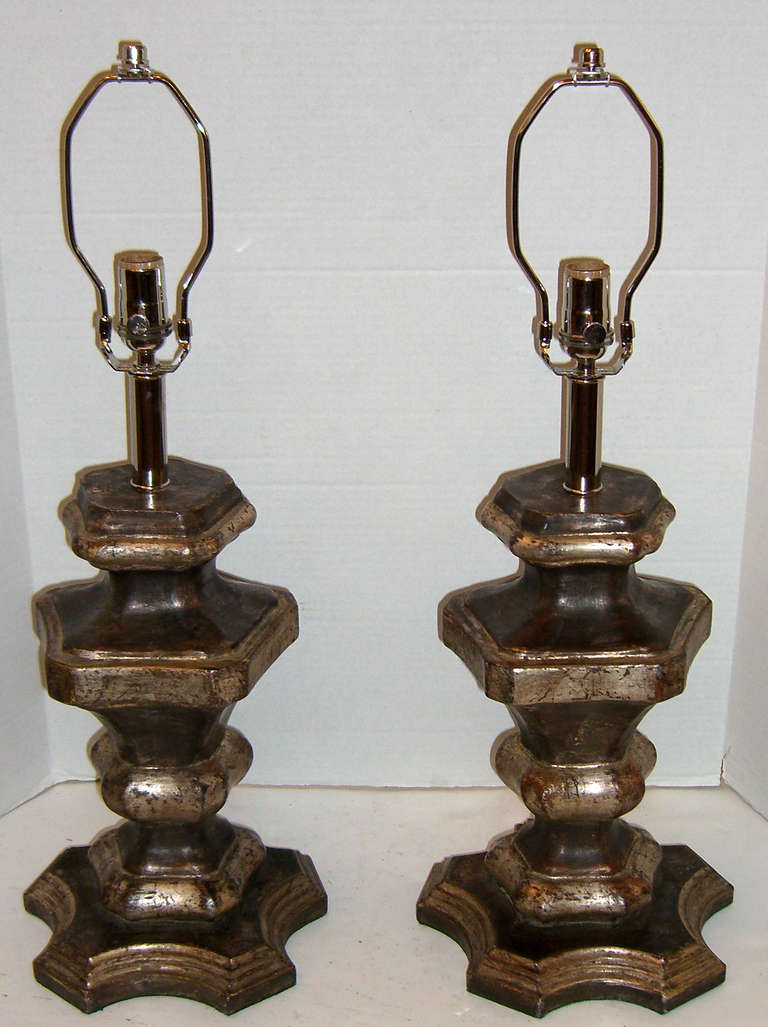 Two large antiqued silver candle pedestals have been transformed to table lamps. 3 way sockets and fabric wrapped cords.