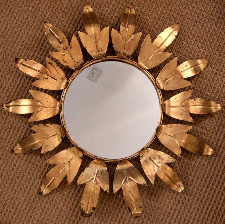 a 1940's Era round Sunburst Mirror of a brightly Gilded Metal.
