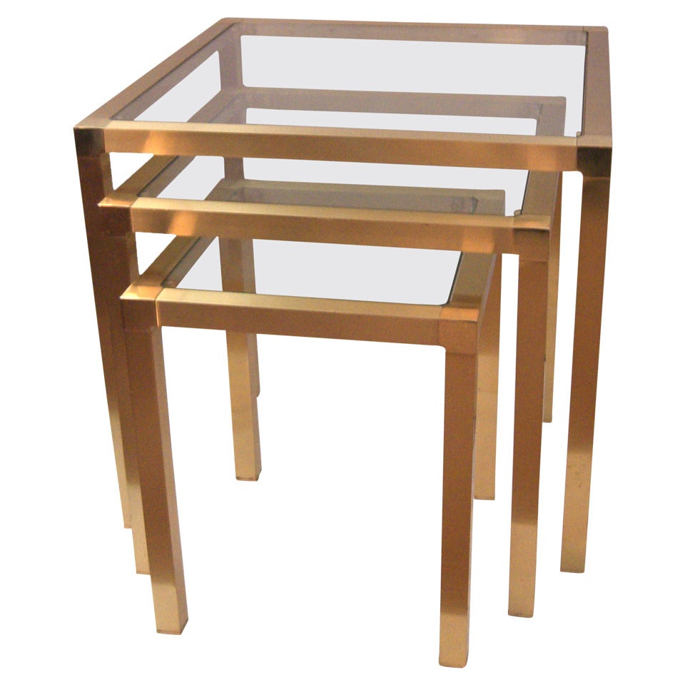 A Set of French Metal Nesting Tables with a Brilliant Gold Finish