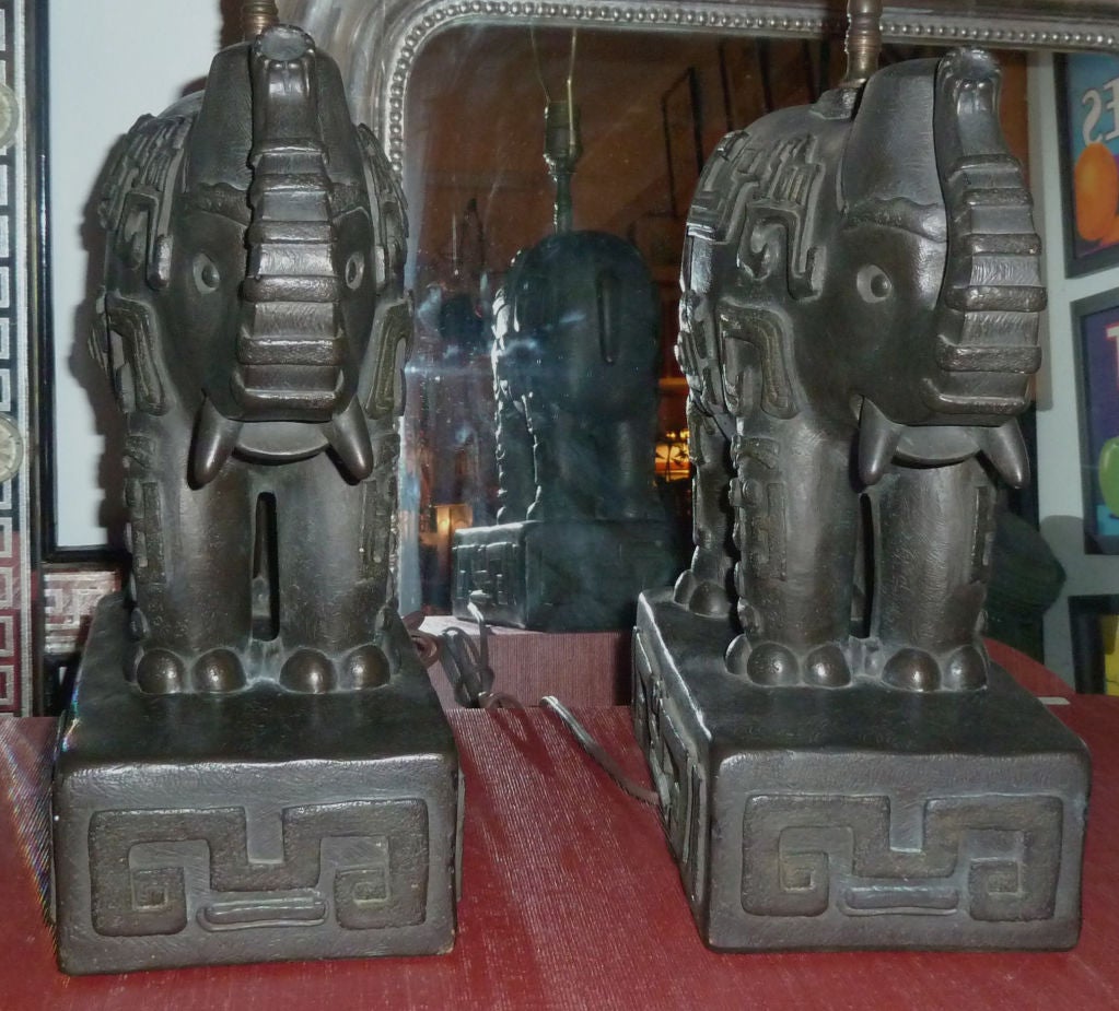A Pair of James Mont style cast plaster elephants adorned with decorative shapes as table lamps.