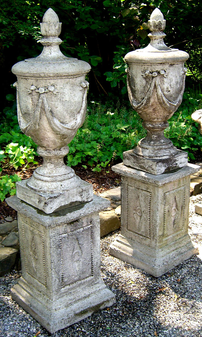 A Stunning Pair of Stone Vase Finials on Plinths