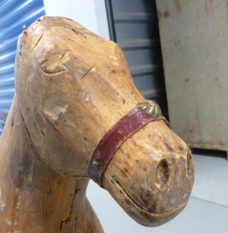 charming child size wooden horse.  All hand carved and painted with the remains of his natural horse hair mane and tail.