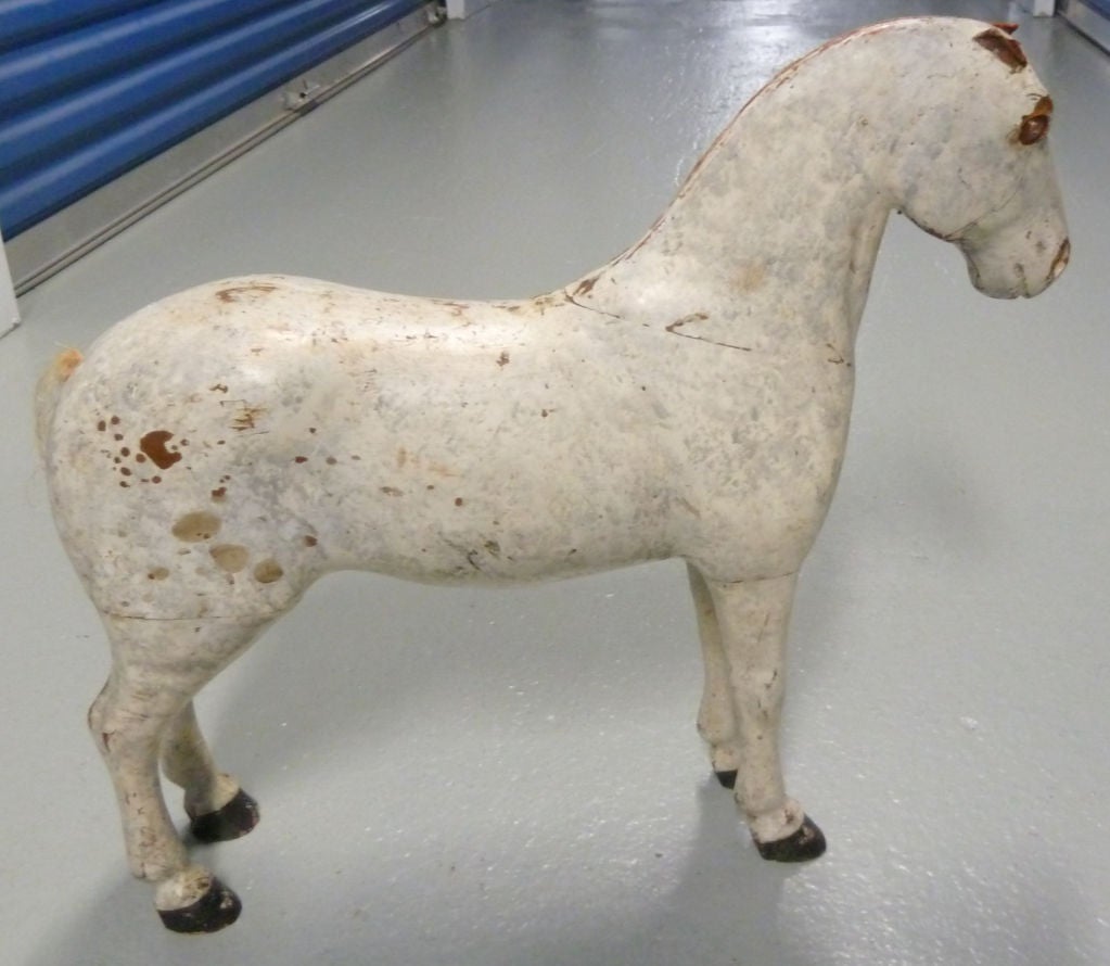White painted wood standing horse.  Hand carved and well proportioned.