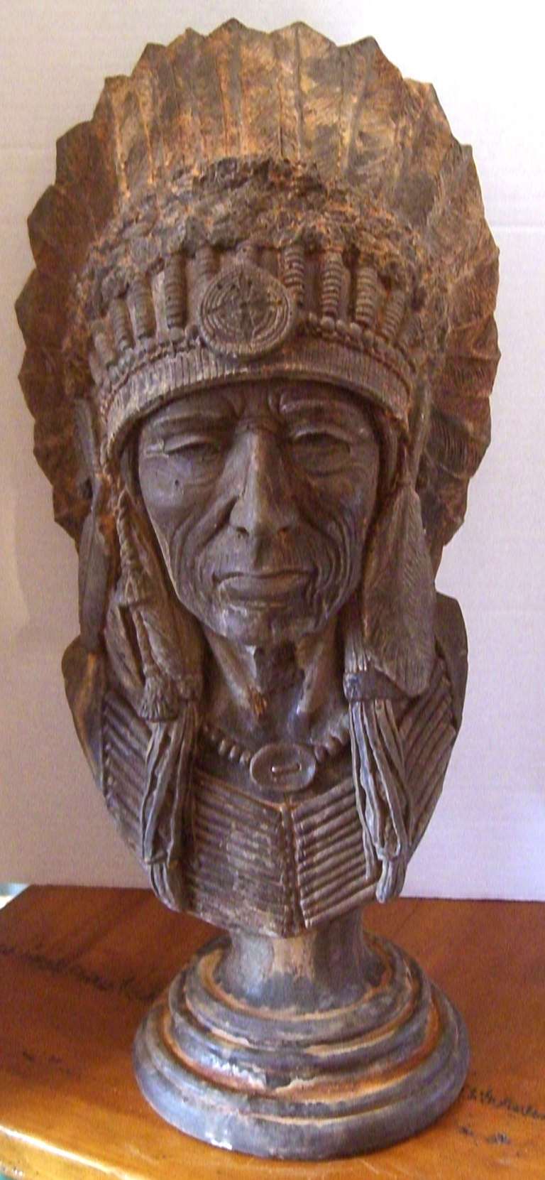 A painted cast stone bust of a Native American Indian Chief in Full Headdress.  Designed and crafted by Gary Apsit.