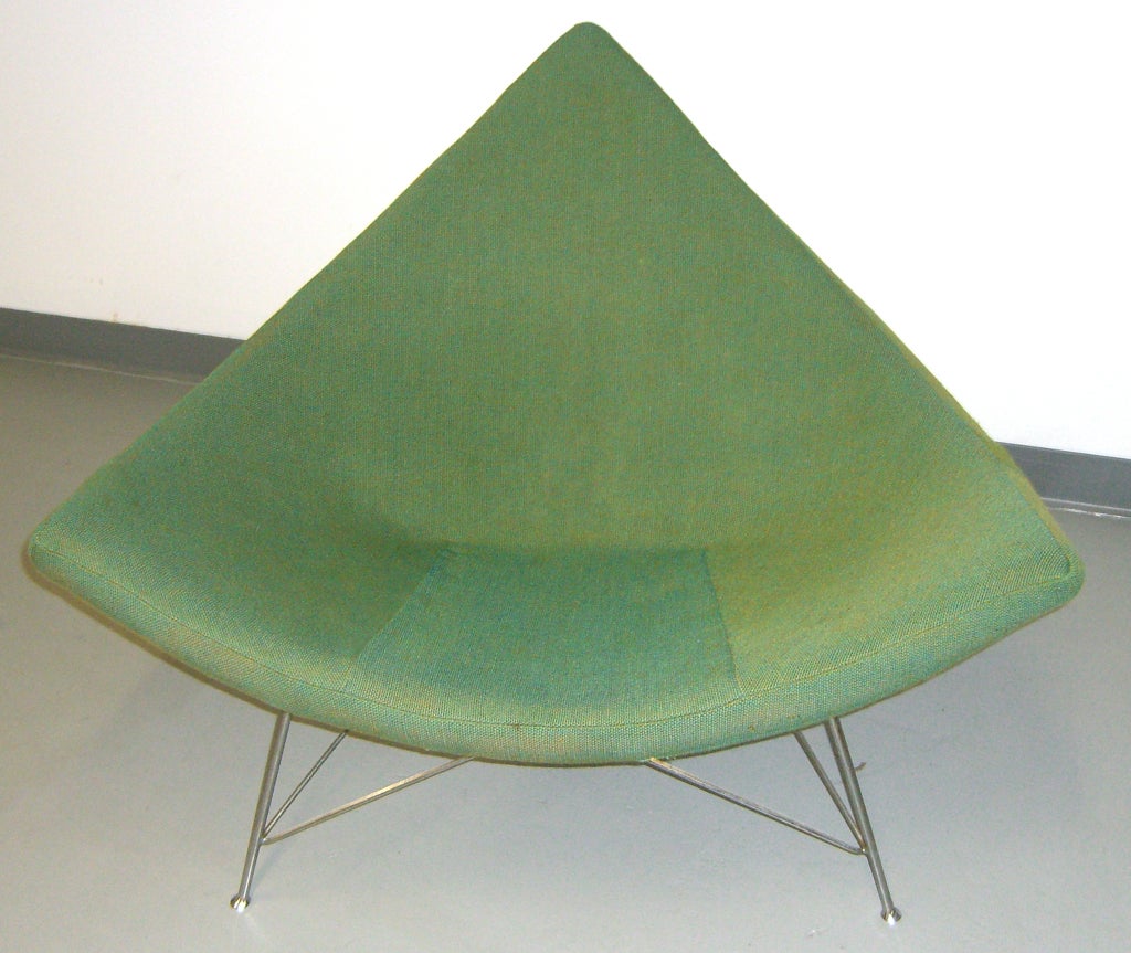 Original blue and green woven fabric covers this iconic mid century chair.  The 