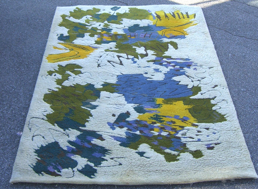 Vivid green, yellow, and blue stand out in the design of this signed Edward Fields rug.