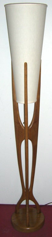 Slender & Sculptural teak floor lamp in a Danish Modern style. Tall cylindrical shade, one socket with a three way brass pull chain.