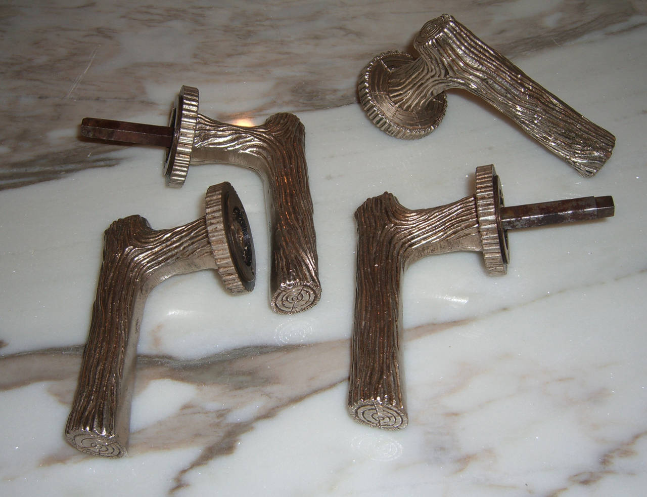 A truly unique matching set of silver plated lever door handles. The faux bois cast design is very detailed.