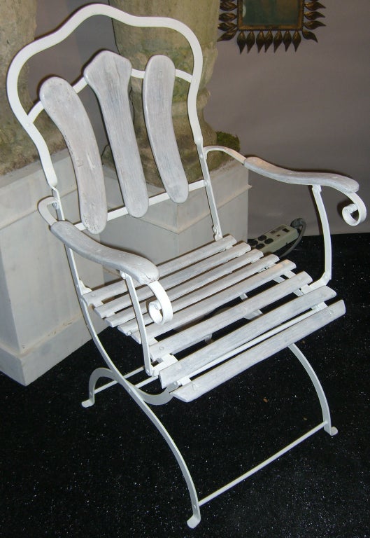 The perfect addition to the garden room.  A set of 4 painted wrought iron chairs with whitewashed wood slats.