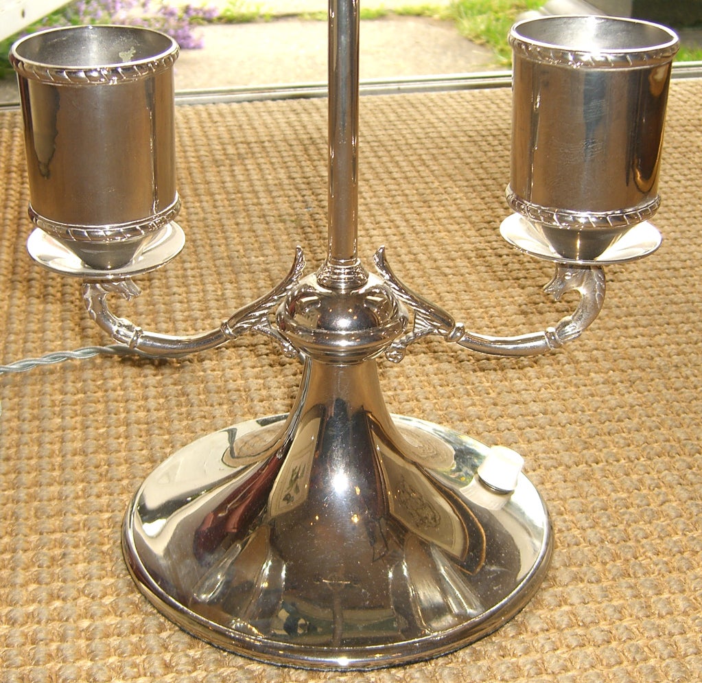 A pair of unique silver plated brass lamps. Each is topped with a decorative 