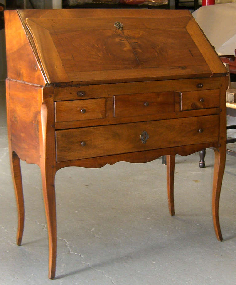 A lovely petite flip down desk with inset brown leather surface. There are four drawers in the interior, and four below.
