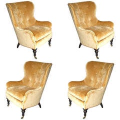 A Set of 4 Upholstered Wingback Chairs on Casters