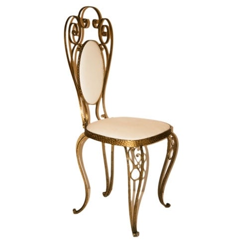 Hammered brass chair with calico-covered seat and back, ideal for the boudoir.